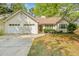 Charming single-Gathering home featuring a two-car garage and well-maintained front yard landscaping at 6095 Wayfarer Dr, Villa Rica, GA 30180