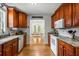 Well-lit kitchen features granite counters, wood cabinets, and stainless steel appliances at 6095 Wayfarer Dr, Villa Rica, GA 30180