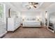 Bright main bedroom features neutral walls, tray ceilings, large windows, and matching dressers at 6095 Wayfarer Dr, Villa Rica, GA 30180