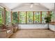 The home includes a screened porch with wood floors and scenic wooded views at 6095 Wayfarer Dr, Villa Rica, GA 30180