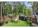 Cozy back deck features artificial grass, outdoor seating, grill and overlooks the wooded yard at 127 Stagecoach Trl, Stockbridge, GA 30281