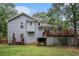 Charming backyard with a deck, storage area, lawn, and surrounded by lush trees at 127 Stagecoach Trl, Stockbridge, GA 30281