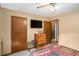 Welcoming bedroom with carpet, wall-mounted television, and dresser at 127 Stagecoach Trl, Stockbridge, GA 30281