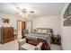 Cozy bedroom with neutral carpet, ceiling fan, and picture frame wall art at 127 Stagecoach Trl, Stockbridge, GA 30281