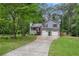 Inviting two-story home with a spacious driveway and mature trees at 127 Stagecoach Trl, Stockbridge, GA 30281