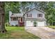 Charming two-story home featuring a well-maintained lawn and a two-car garage at 127 Stagecoach Trl, Stockbridge, GA 30281