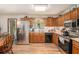 Well-equipped kitchen featuring stainless steel appliances, wood cabinets, and tiled backsplash at 127 Stagecoach Trl, Stockbridge, GA 30281