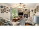 Comfortable living room featuring sofas, a stone fireplace, and a large window at 127 Stagecoach Trl, Stockbridge, GA 30281