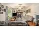 Cozy living room features a stone fireplace, plush sofas, and plenty of natural light at 127 Stagecoach Trl, Stockbridge, GA 30281