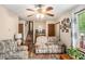 Inviting living room with cozy seating, a ceiling fan, and natural light at 127 Stagecoach Trl, Stockbridge, GA 30281