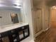 Bathroom features a double sink vanity with decorative accents and a glass enclosed shower at 236 Bobbie Way, Woodstock, GA 30189