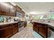 Well-equipped kitchen with stainless steel appliances, wood cabinets and seamless flow to dining at 236 Bobbie Way, Woodstock, GA 30189