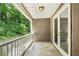 Covered balcony that overlooks a green area with a small privacy wall at 44 Saint Claire Ne Ln, Atlanta, GA 30324