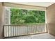 Balcony with views of a tree-lined backdrop with a stone block railing at 44 Saint Claire Ne Ln, Atlanta, GA 30324