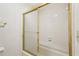 Close-up of the bright gold-trimmed shower and white tile in the bathroom at 44 Saint Claire Ne Ln, Atlanta, GA 30324