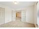 Large bedroom with French doors, plush carpeting, and access to other rooms at 44 Saint Claire Ne Ln, Atlanta, GA 30324