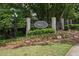 Welcoming Walden community entrance with sign, mature trees and landscaped garden at 44 Saint Claire Ne Ln, Atlanta, GA 30324