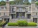 Attractive townhome with neutral stucco exterior, arched windows, dark doors, and manicured landscaping at 44 Saint Claire Ne Ln, Atlanta, GA 30324