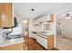 Bright kitchen with white cabinets, hardwood floors, and a view into an adjacent living area at 44 Saint Claire Ne Ln, Atlanta, GA 30324