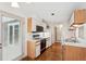 Galley kitchen featuring white cabinets, appliances, and hardwood flooring throughout at 44 Saint Claire Ne Ln, Atlanta, GA 30324