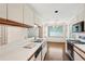 Spacious kitchen area with hardwood floors and view into separate dining space at 44 Saint Claire Ne Ln, Atlanta, GA 30324
