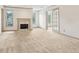 Cozy living room filled with natural light features a fireplace and access to a separate room via glass doors at 44 Saint Claire Ne Ln, Atlanta, GA 30324