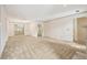 Spacious living room showcasing plush carpeting, white walls, a fireplace, and stylish lighting at 44 Saint Claire Ne Ln, Atlanta, GA 30324