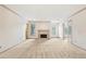Open living room with a fireplace, glass paneled doors, and lots of natural light at 44 Saint Claire Ne Ln, Atlanta, GA 30324