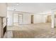 Expansive living room with a fireplace, neutral carpet, and white walls and trim at 44 Saint Claire Ne Ln, Atlanta, GA 30324