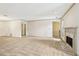 Bright living room featuring a marble fireplace, plush carpeting, white walls, and large windows at 44 Saint Claire Ne Ln, Atlanta, GA 30324