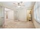 Office area with neutral walls, carpet, fan, glass doors and access to additional rooms at 44 Saint Claire Ne Ln, Atlanta, GA 30324