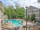 Community pool area with plenty of lounge chairs, lush greenery, and a serene atmosphere for residents to relax at 44 Saint Claire Ne Ln, Atlanta, GA 30324