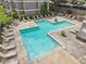 A community pool with tanning chairs and manicured planters for a resort-style living experience at 44 Saint Claire Ne Ln, Atlanta, GA 30324