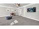 A neutral-toned room with gray walls, carpeting, a ceiling fan, an office area, and a flat-screen television at 5003 Fairview Cir, Villa Rica, GA 30180