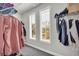 Functional walk-in closet with wire shelving, hanging clothes, and natural light from two windows at 5003 Fairview Cir, Villa Rica, GA 30180
