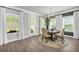 Bright dining area features a modern chandelier and ample natural light from large windows at 5003 Fairview Cir, Villa Rica, GA 30180