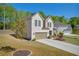 Charming two-story home with a brick exterior, attached garage, and a well-maintained front yard at 5003 Fairview Cir, Villa Rica, GA 30180