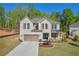 Stunning two-story home with a brick facade, complemented by a manicured lawn and a cozy covered front porch at 5003 Fairview Cir, Villa Rica, GA 30180