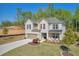 Beautiful two-story home featuring a brick facade, attached garage, landscaped front yard, and covered porch at 5003 Fairview Cir, Villa Rica, GA 30180