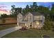 Beautiful two-story home featuring a brick facade, attached garage, landscaped front yard, and covered porch at 5003 Fairview Cir, Villa Rica, GA 30180
