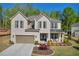 Charming two-story home with a brick facade, complemented by a manicured lawn and a cozy covered front porch at 5003 Fairview Cir, Villa Rica, GA 30180