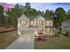 Stunning two-story home with a brick facade, complemented by a manicured lawn and a cozy covered front porch at 5003 Fairview Cir, Villa Rica, GA 30180