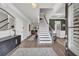 Bright foyer features a staircase, wood floors, decorative mirror, and view to the living room at 5003 Fairview Cir, Villa Rica, GA 30180