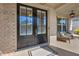 Close-up of double doors leading to front porch with seating and lighting at 5003 Fairview Cir, Villa Rica, GA 30180