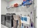 Functional laundry room features front load washer/dryer and ample storage shelf above the sink at 5003 Fairview Cir, Villa Rica, GA 30180