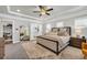 This is a carpeted main bedroom with a ceiling fan, bedside tables, and a walk-in closet at 5003 Fairview Cir, Villa Rica, GA 30180