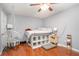 Bedroom with suspended chair, storage shelves, and hardwood floors at 6450 Ivey Se Rd, Mableton, GA 30126