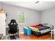 Well-lit bedroom with wood flooring, desk, and window for plenty of natural light at 6450 Ivey Se Rd, Mableton, GA 30126