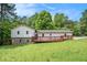 Charming home with a large front yard and inviting deck area, perfect for outdoor relaxation at 6450 Ivey Se Rd, Mableton, GA 30126