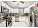 Bright kitchen with stainless steel appliances, granite countertops and ample storage at 6450 Ivey Se Rd, Mableton, GA 30126